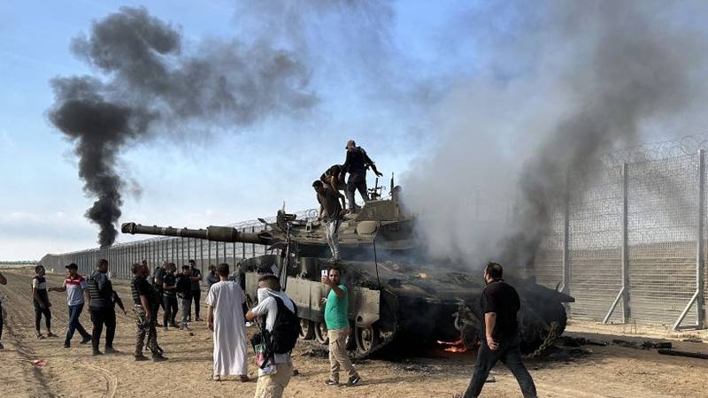 GAZA CITY, GAZA - OCTOBER 07: Smoke rises after Palestinian members of the Ezz Al-Din Al Qassam Brigades, the military wing of Hamas burn military armored vehicle belonging to Israeli forces near Gaza Strip, Gaza on October 07, 2023. (Photo by Ashraf Amra/Anadolu Agency via Getty Images)