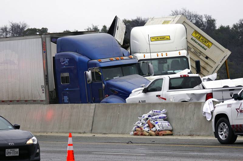 Vehicles are piled up after a fatal crash on Interstate 35 near Fort Worth, Texas on Thursday, Feb. 11, 2021.  The massive crash involving 75 to 100 vehicles on an icy Texas interstate killed some and injured others, police said, as a winter storm dropped freezing rain, sleet and snow on parts of the U.S.