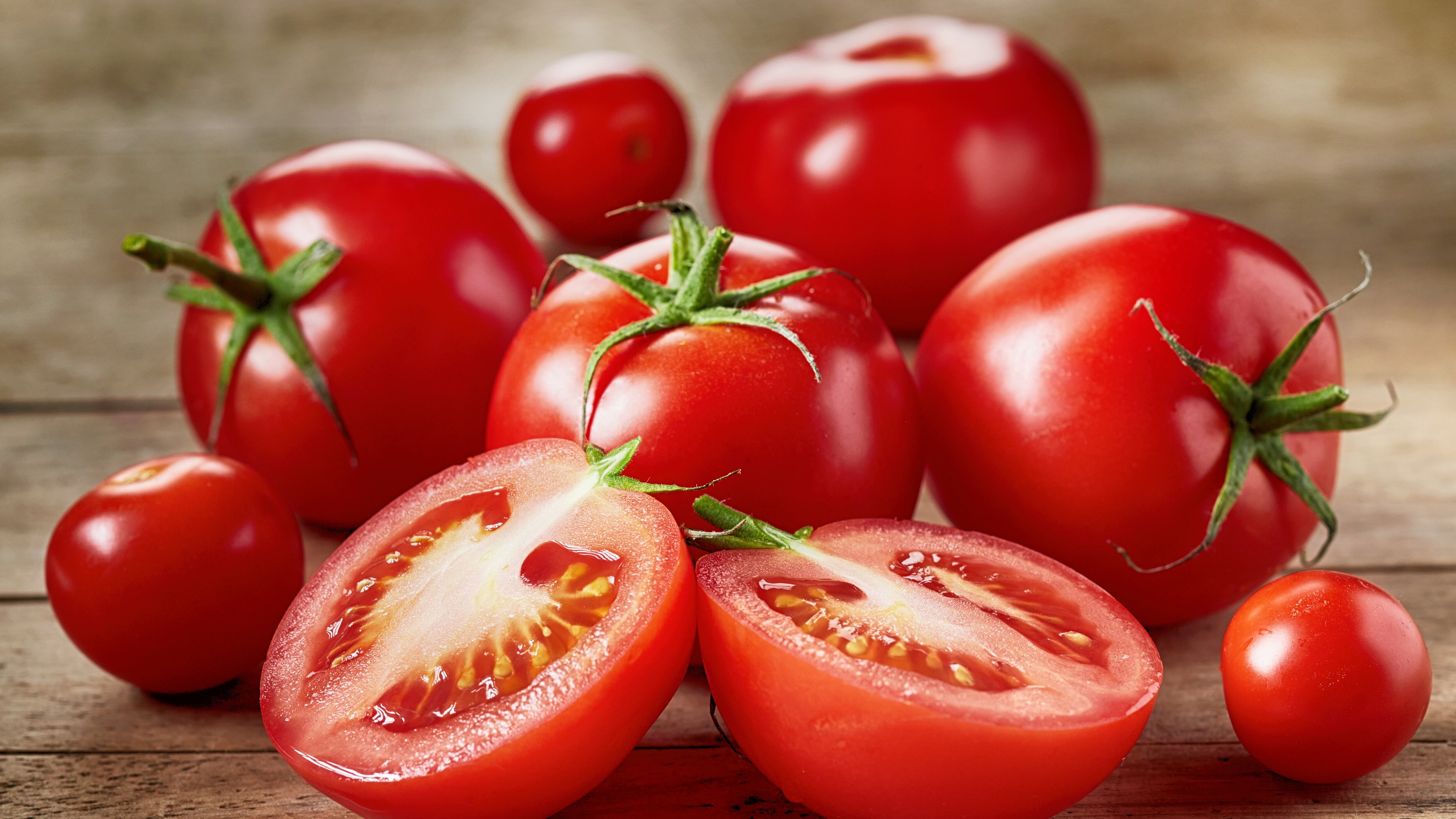 Fresh red tomatoes on wooden table