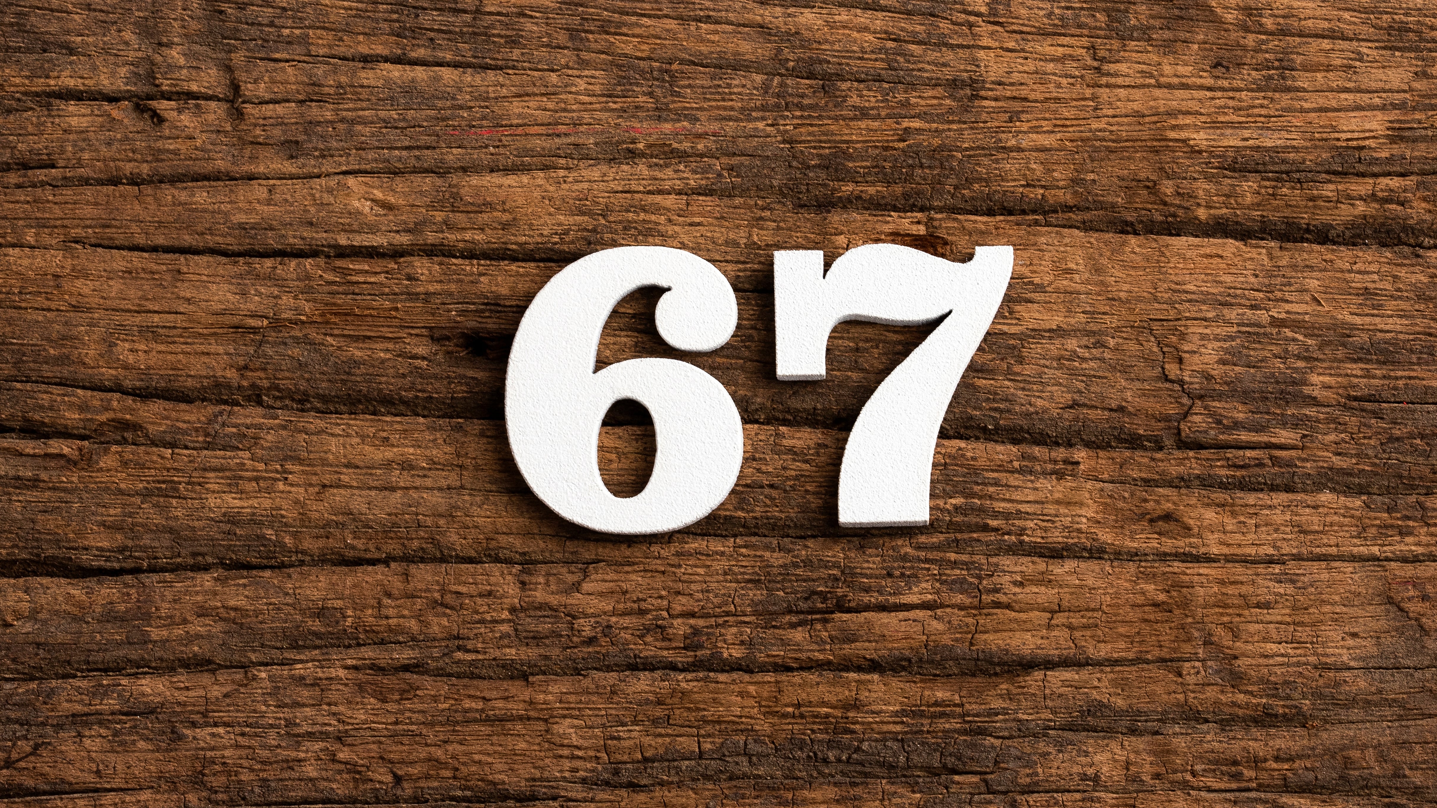Number 67 - piece on rustic wood background