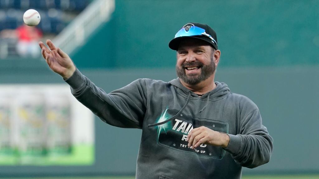 KANSAS CITY, MISSOURI - AUGUST 29: Country artist Garth Brooks throws out the first pitch prior to a game between the Pittsburgh Pirates and Kansas City Royals at Kauffman Stadium on August 29, 2023 in Kansas City, Missouri. (Photo by Ed Zurga/Getty Images)
