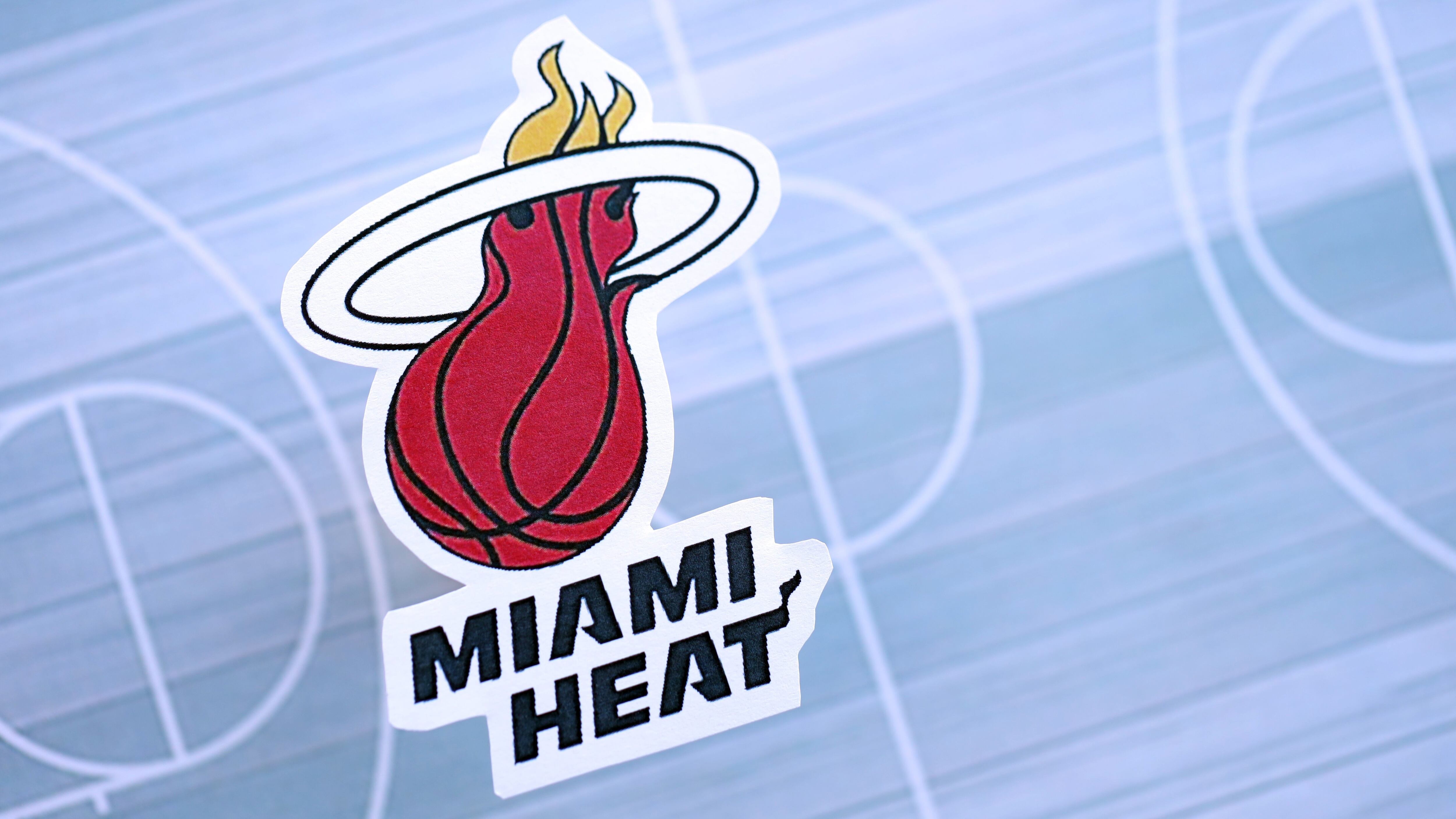 Miami Heat basketball team logo lies on a basketball court